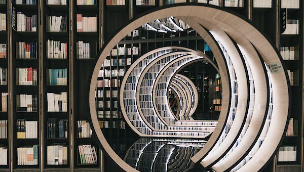 Bücherregale in Bibliothek mit Durchgang zu weiteren Räumen