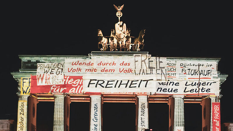 Brandenburg Gate illuminated with letterings on freedom and reunification from the year 1989