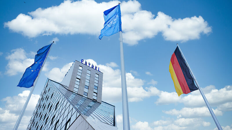 EU, German and UN flags waving in front of Estrel Berlin.