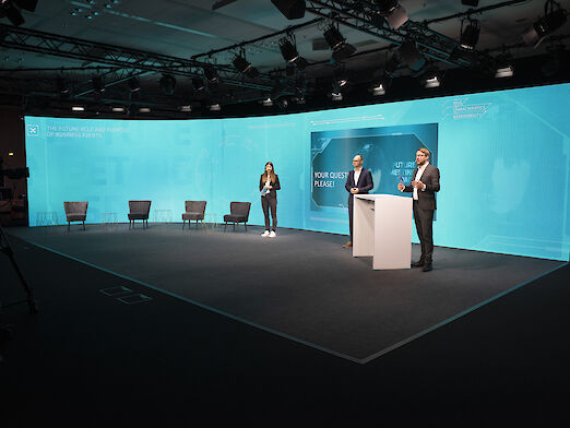Matthias Schultze, Katharina Dienes and Tilman Naujoks from Fraunhofer IAO giving a presentation on stage.