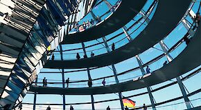 The glass dome of the German Bundestag can be seen from the inside, through one of the windows you can see the German flag