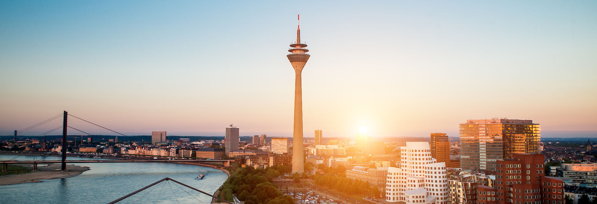 City panorama Düsseldorf with the river Rhine at sunset