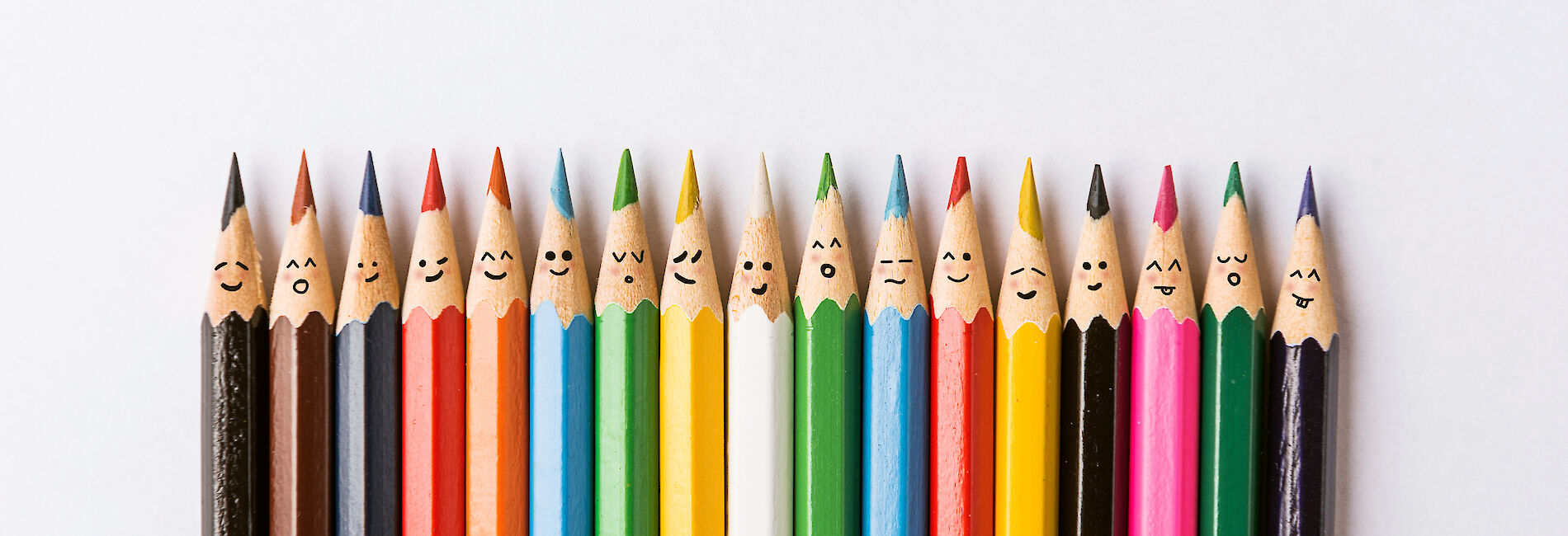 Colorful pencils with faces